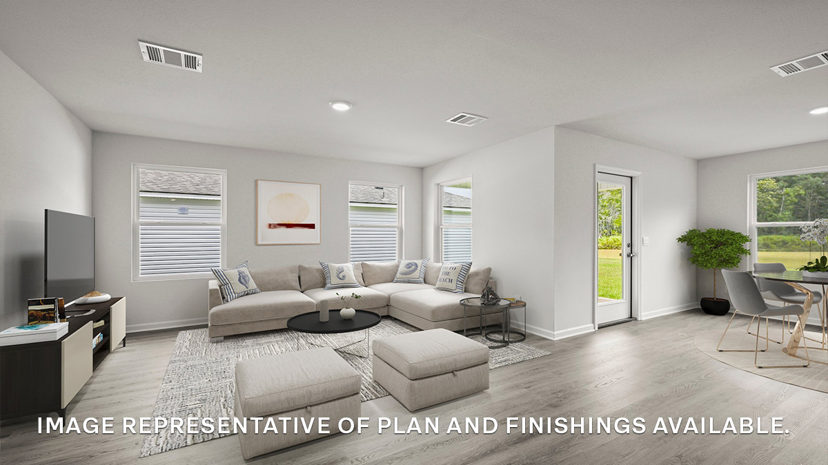 Open-concept living room with dual windows facing backyard