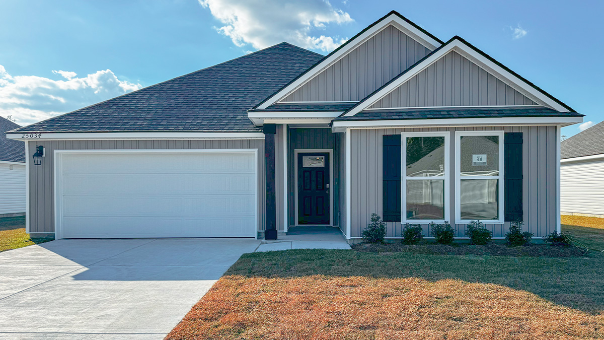 single-story home with gray vinyl siding and black front door and shutters with two-car garage