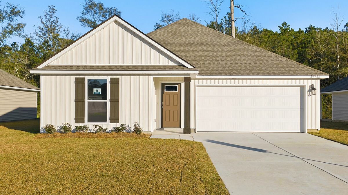 single-story home with white vinyl and brown front door and shutters with two-car garage