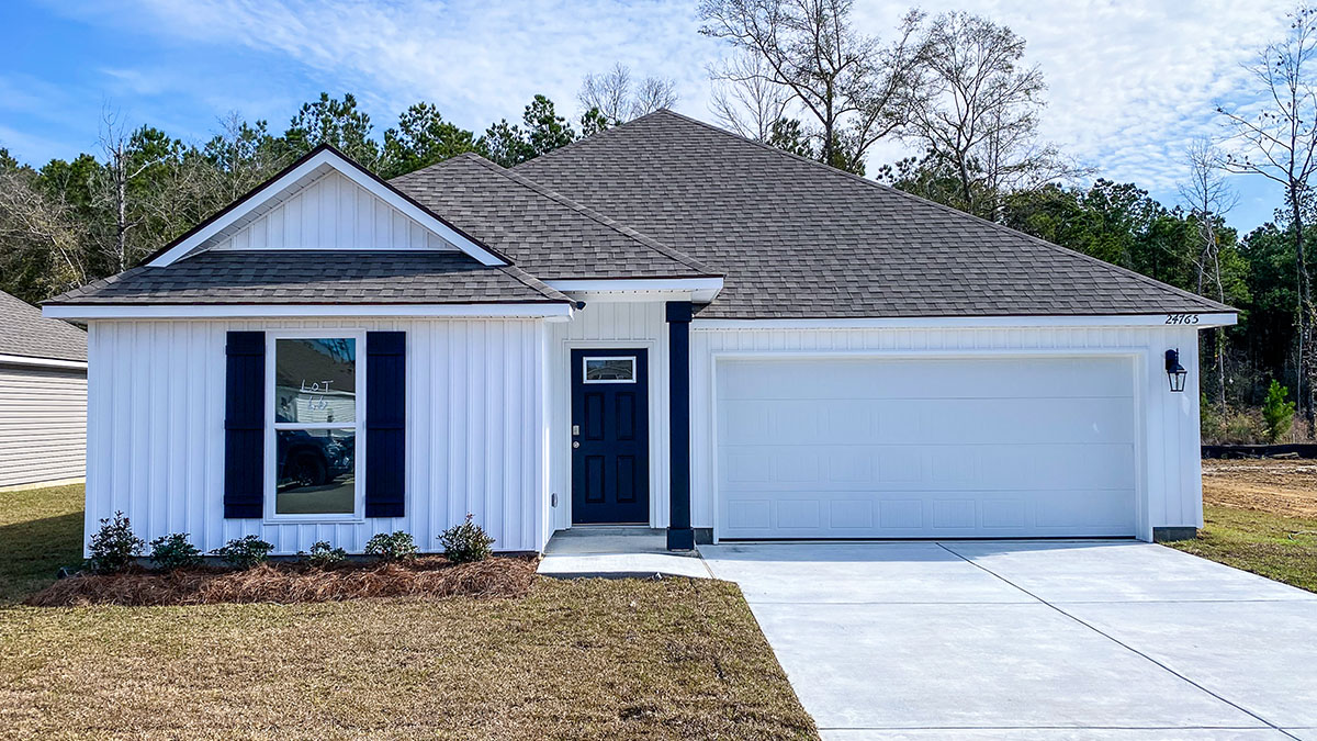 single-story home with white vinyl siding with black front door and shutters with two-car garage