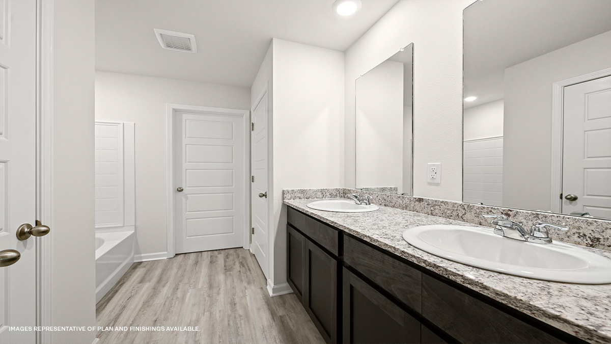Dual vanities and garden tub in primary bathroom