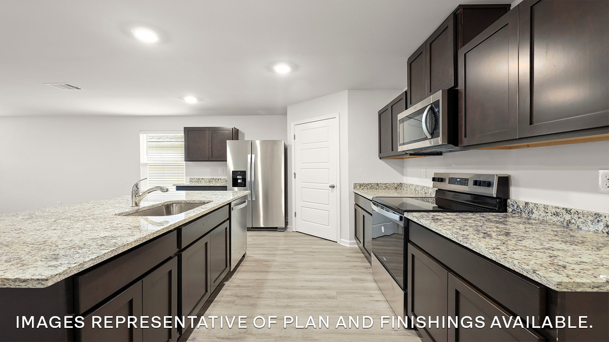 white kitchen island with stainless steel appliances and pantry