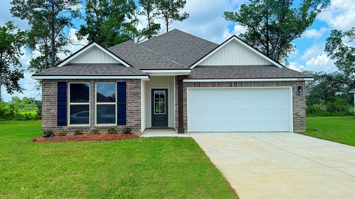 single-story home with gray brick and tan vinyl siding with black front door and shutters with porch and two-car garage