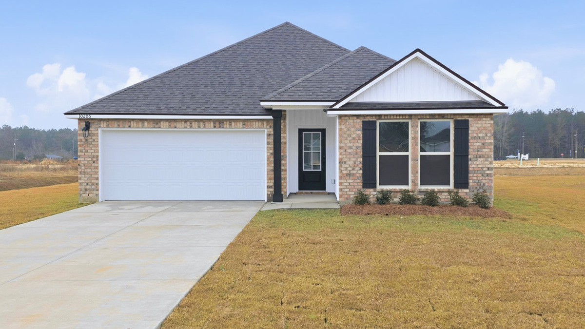 single-story home with tan brick and white vinyl siding with black front door and shutters with two-car garage