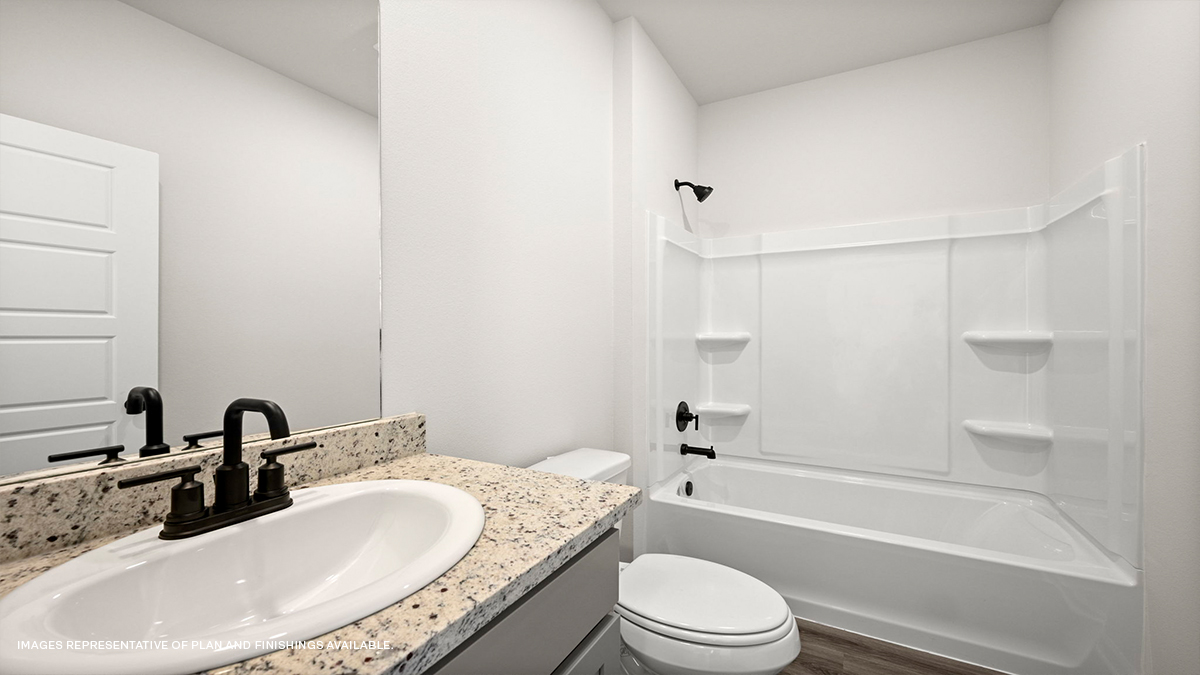 Guest bathroom with single vanity and shower tub combo