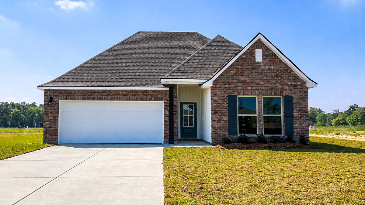 single-story home with red brick and black front door and shutters with two-car garage