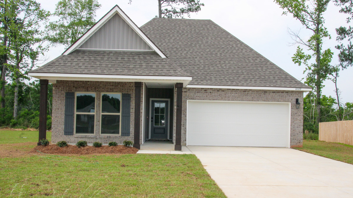single-story home with gray brick and gray vinyl siding and gray front door and shutters with porch and two-car garage