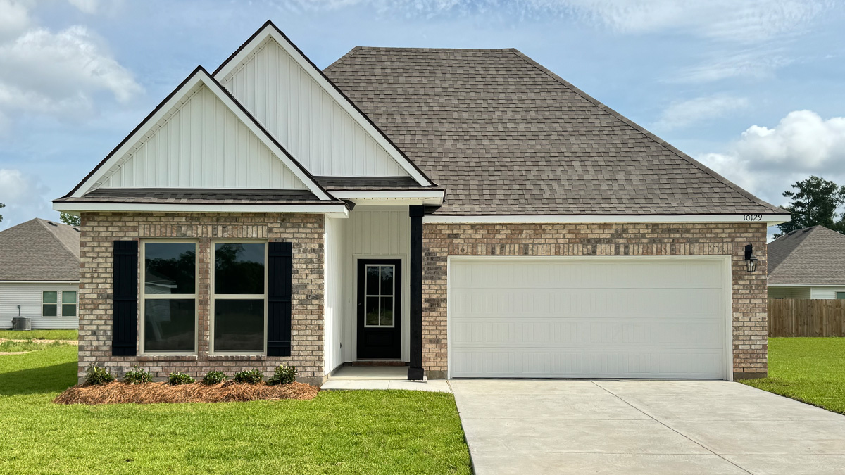 Single-story home with brown brick and white vinyl. Black glass front door with black shutters and white trim.