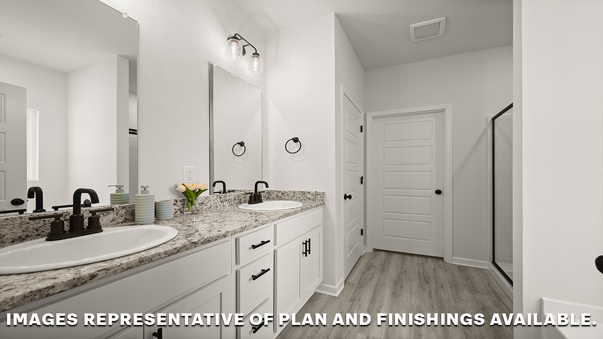 White dual vanities with separate shower and closet door