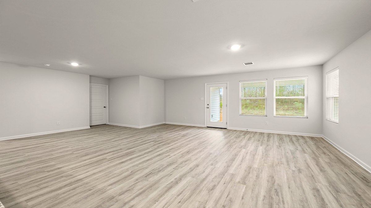 spacious living room with dual windows in the rear and dual windows facing the side