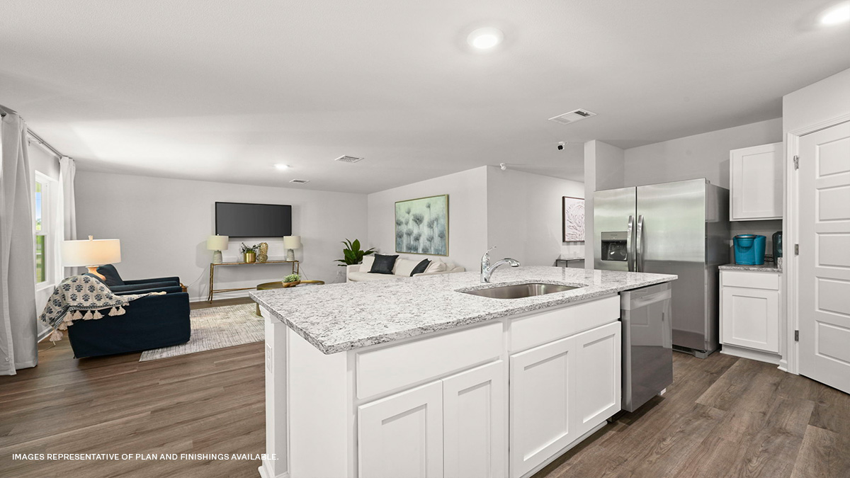 white kitchen cabinets and island with stainless steel appliances and foyer access