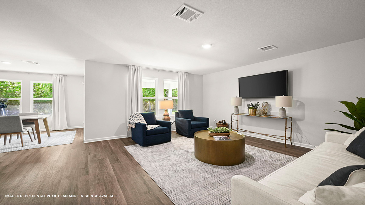 Spacious living room in the rear of home with dual windows facing backyard