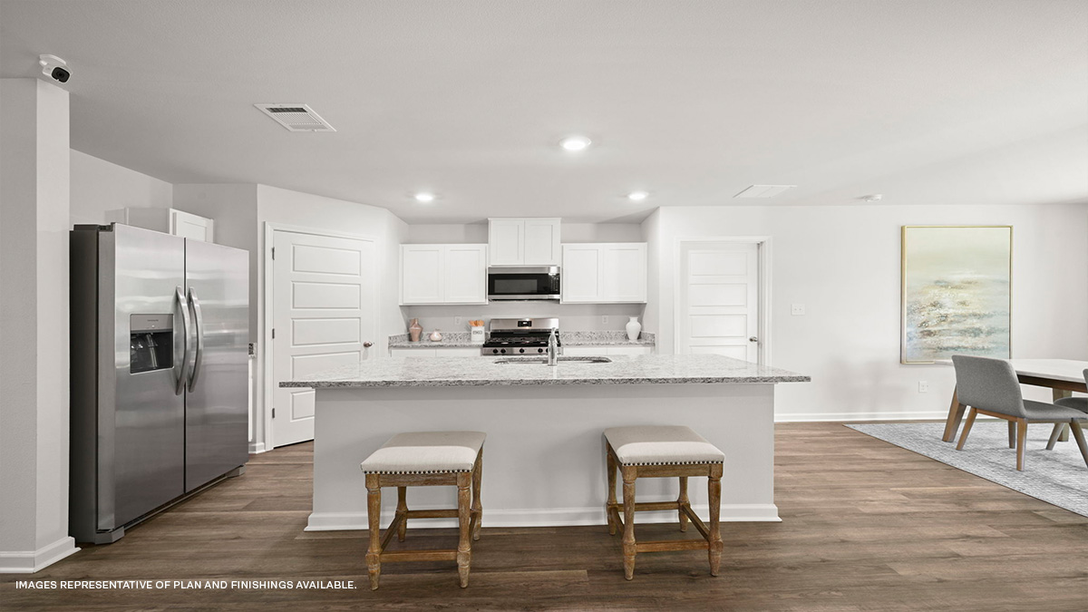 white kitchen island and cabinets with stainless steel stove and microwave hood