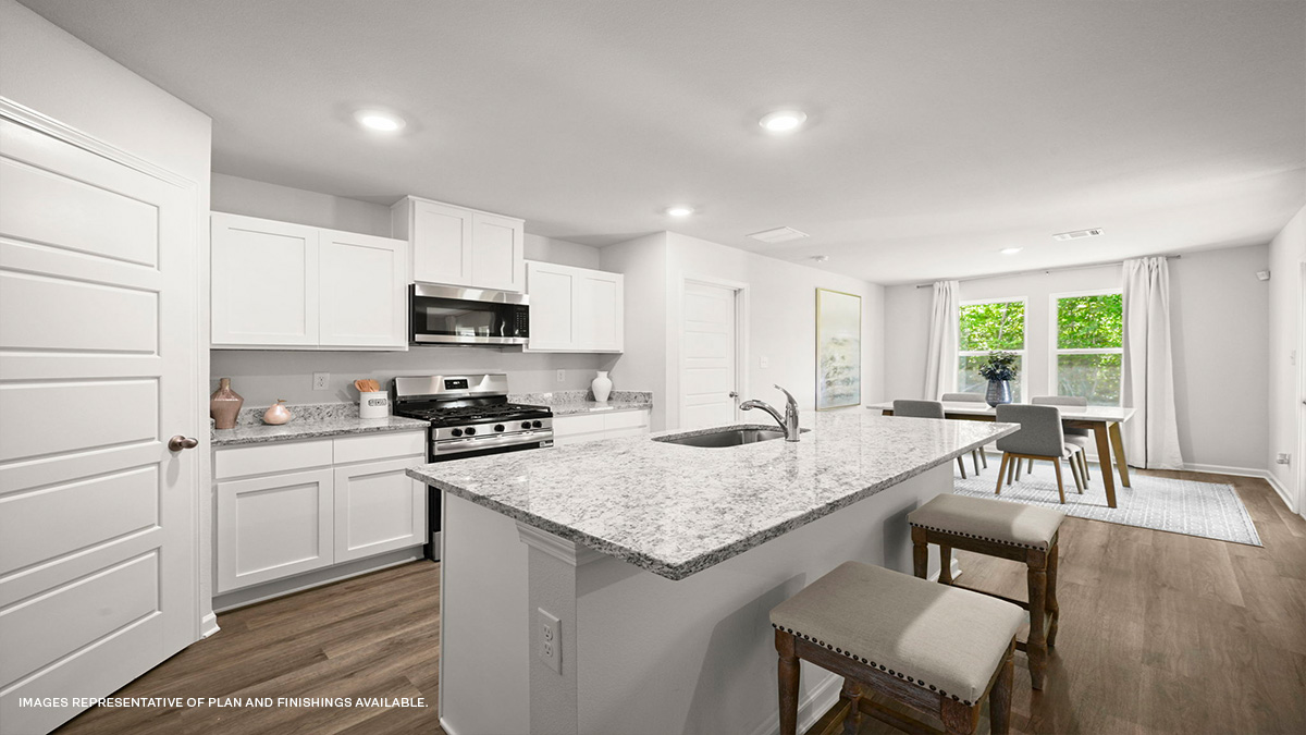 white kitchen island and cabinets with stainless steel stove and microwave hood