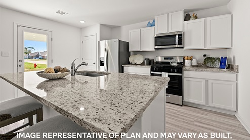 white kitchen island with stainless steel appliances
