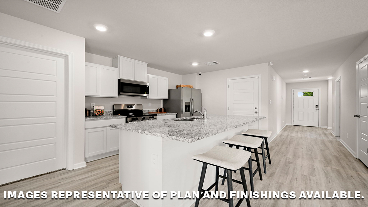 White kitchen island and foyer with access to front of home