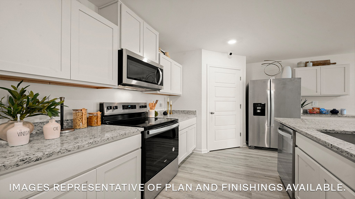 white kitchen island with stainless steel appliances and pantry access