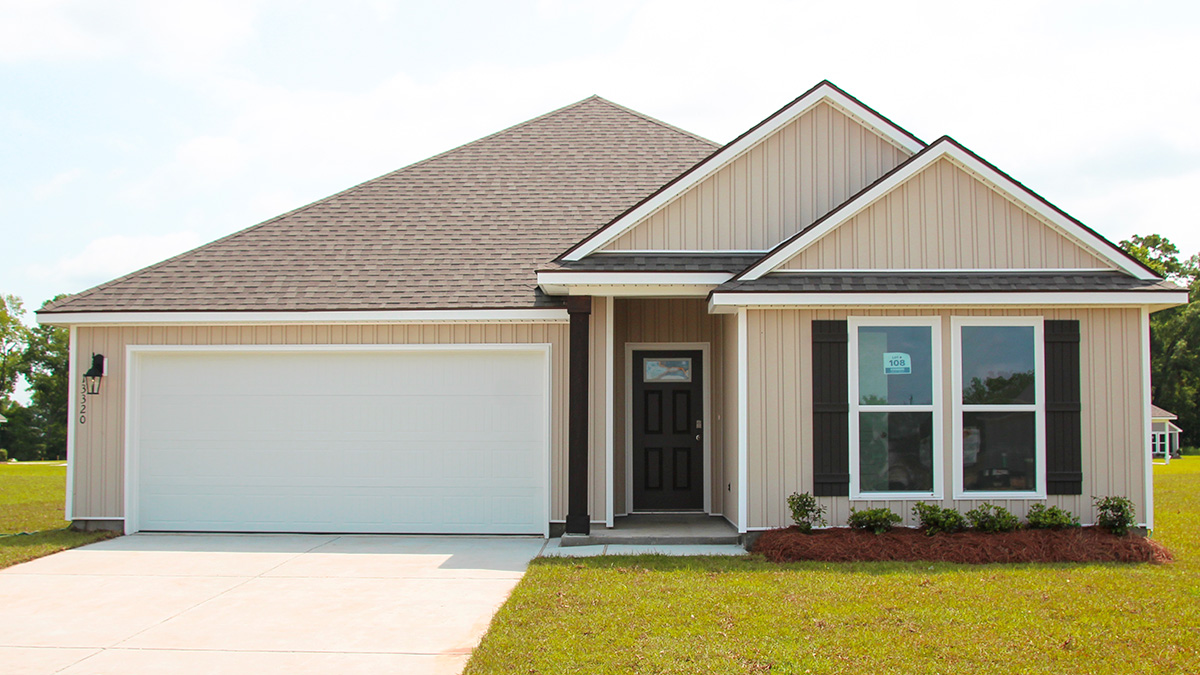 Single-story home with tan brick. Black glass front door with black shutters and white trim.