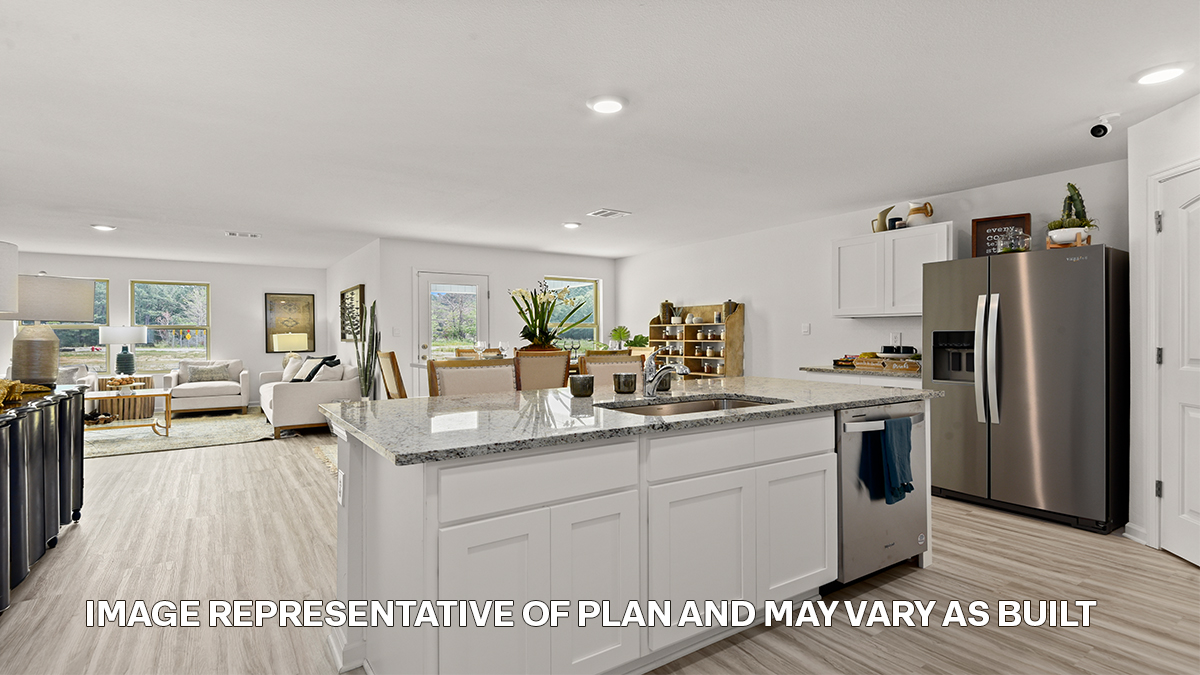 white kitchen island with stainless steel appliances and pantry access