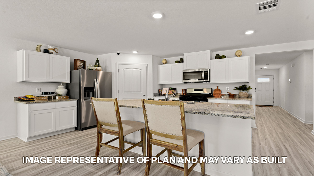 white kitchen island with stainless steel appliances and pantry access