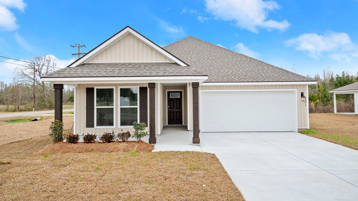 single-story home with tan vinyl siding and brown front door and shutters with two-car garage and porch