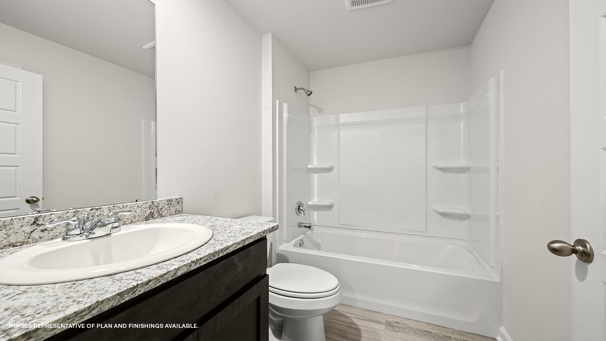 Guest bathroom with vanity, mirror, toilet and shower tub combo