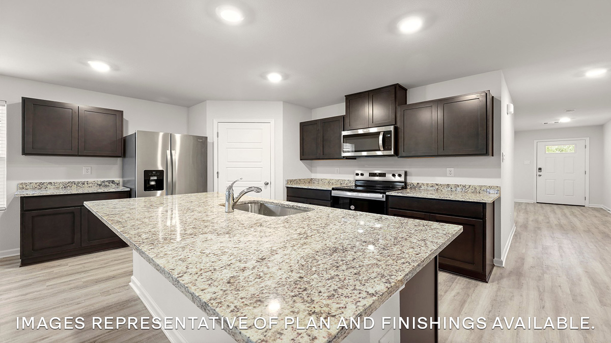 White kitchen island with stainless steel appliances and pantry