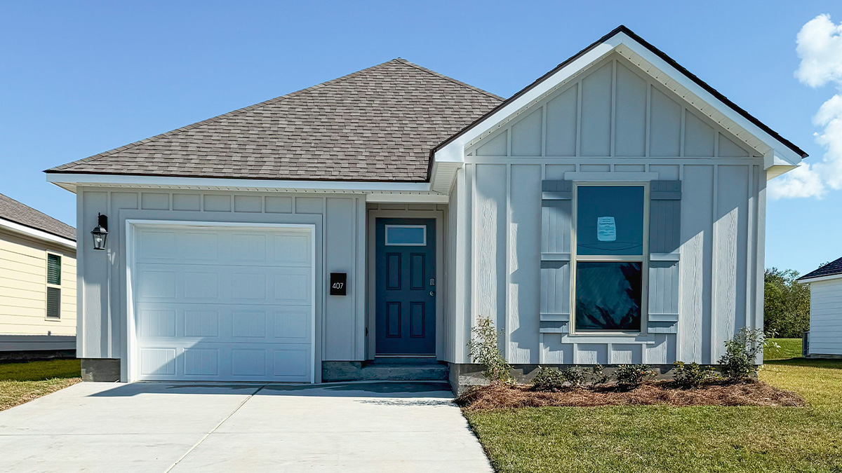 single-story home with light gray vinyl siding with gray front door and shutters with one-car garage