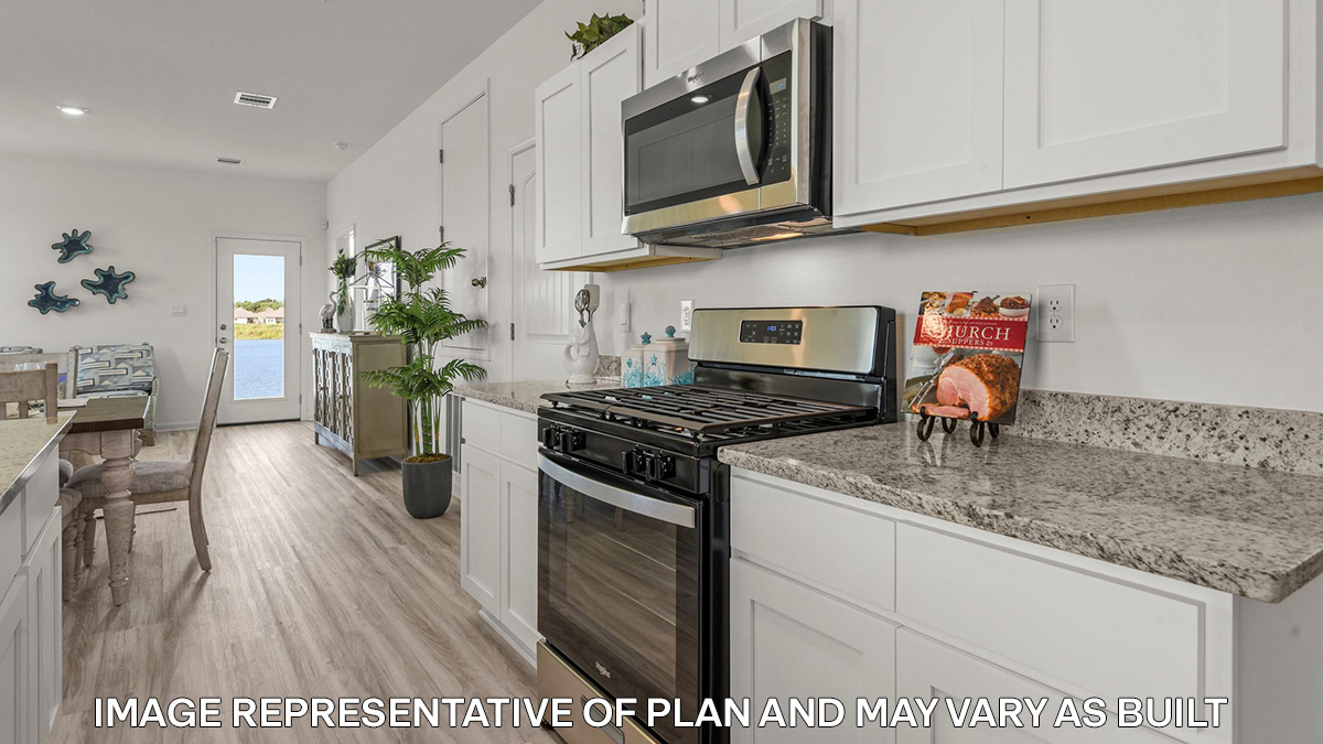 white kitchen island with stainless steel appliances with access to the dining room