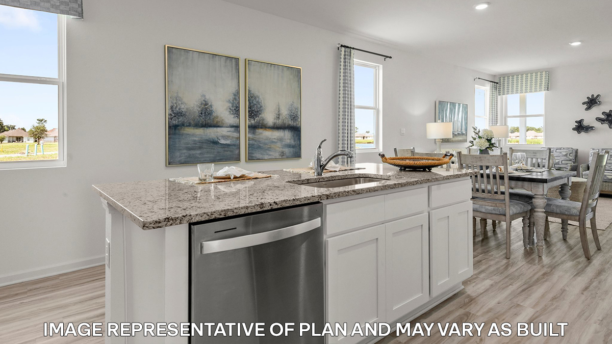 white kitchen island with stainless steel appliances with access to the dining room