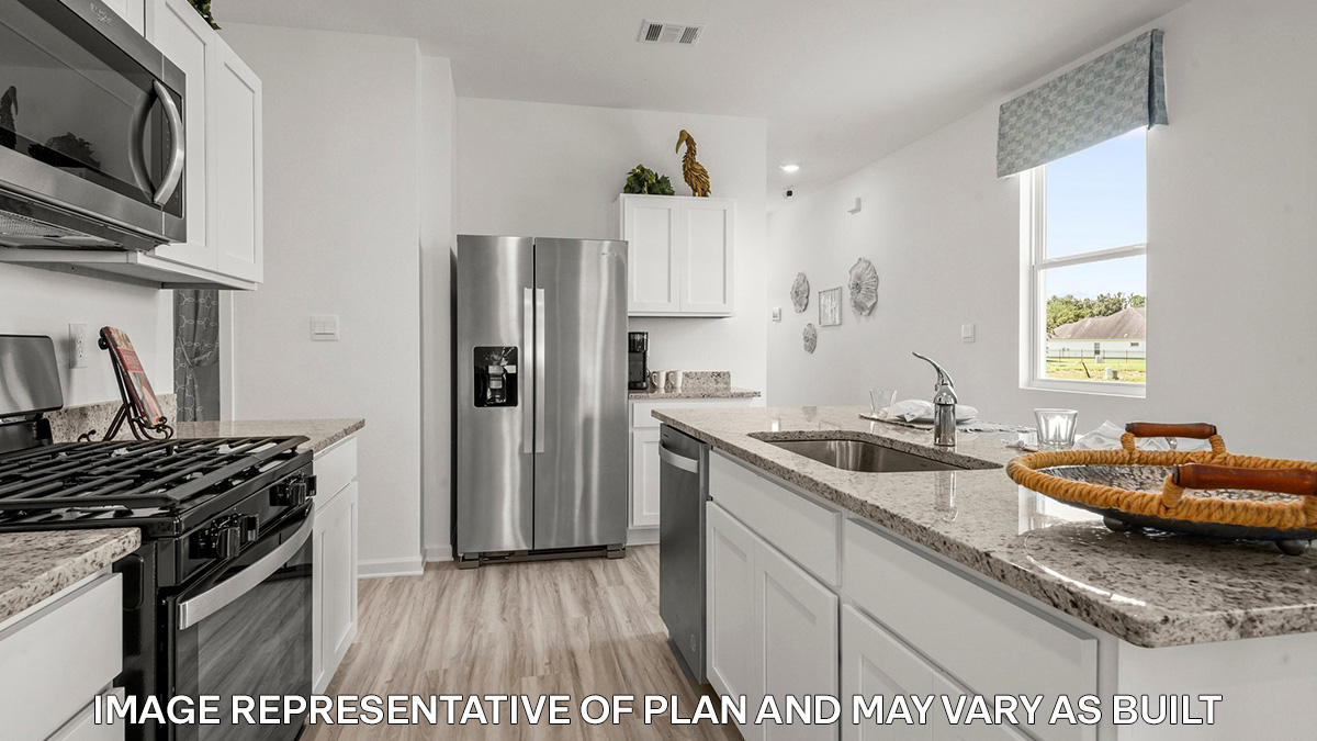 white kitchen island with stainless steel appliances