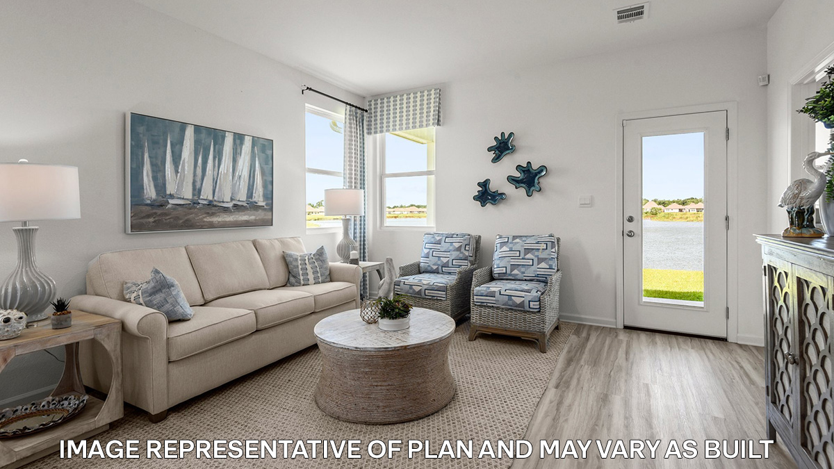 spacious living room with dual windows overlooking backyard