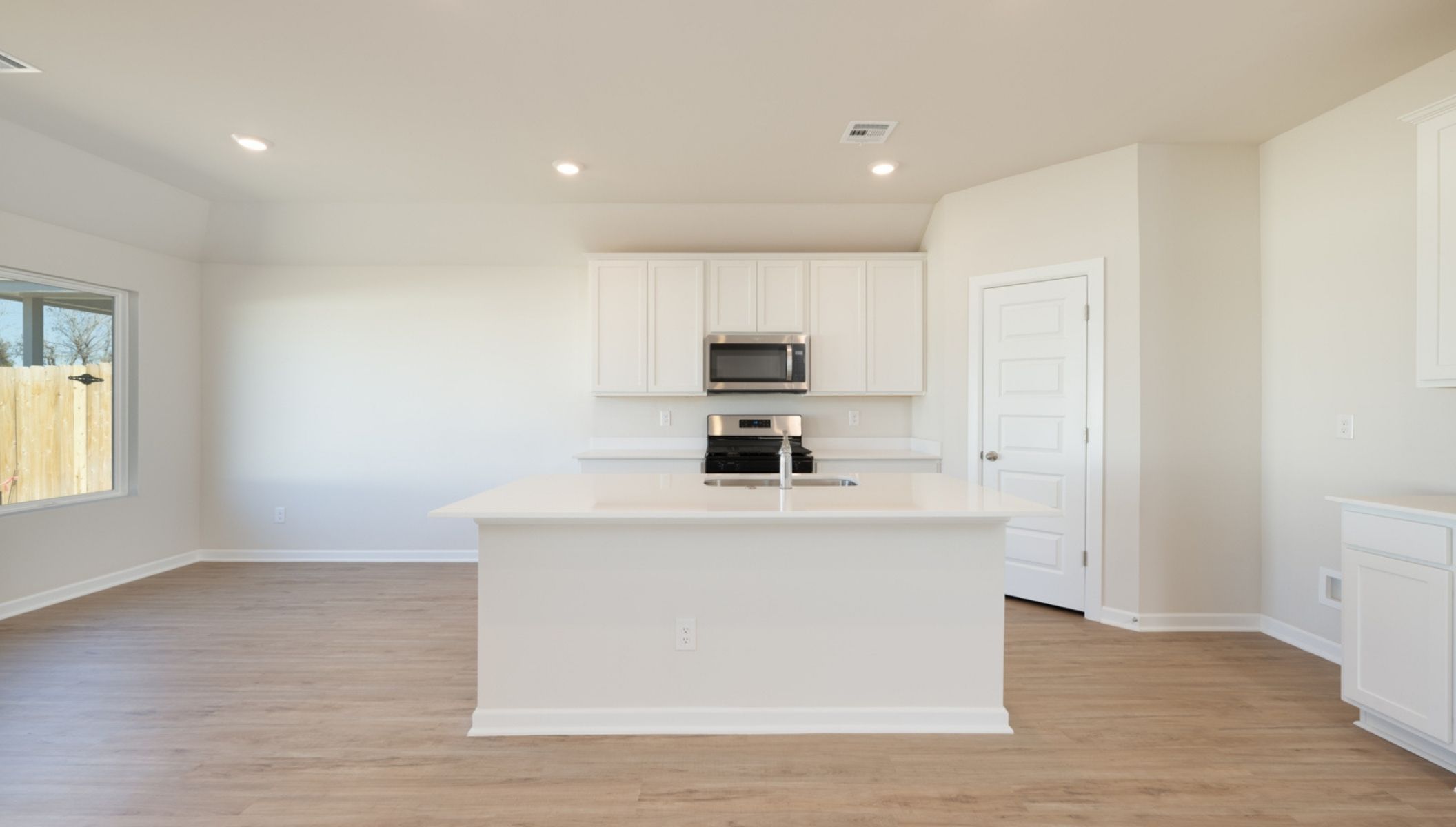 Modern open-concept living and kitchen area with granite countertops