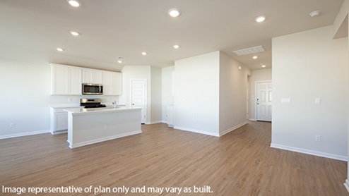 Modern open-concept living and kitchen area with granite countertops