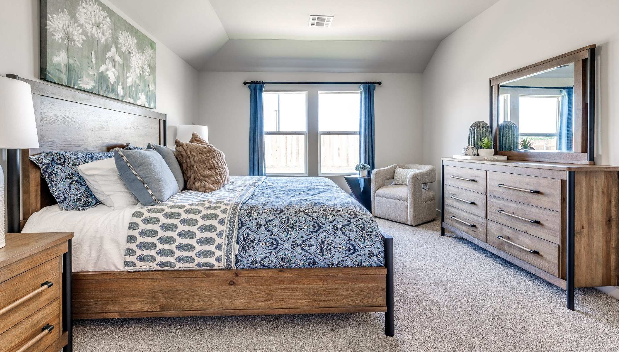 primary bedroom with carpet and large window