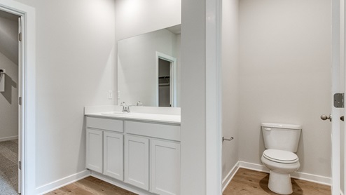 primary bathroom with enclosed toliet