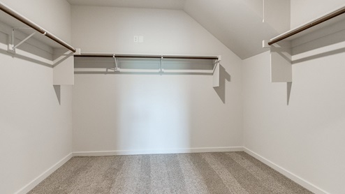 primary closet with hanging rods
