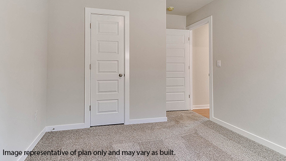 Guest bedroom with carpet and window