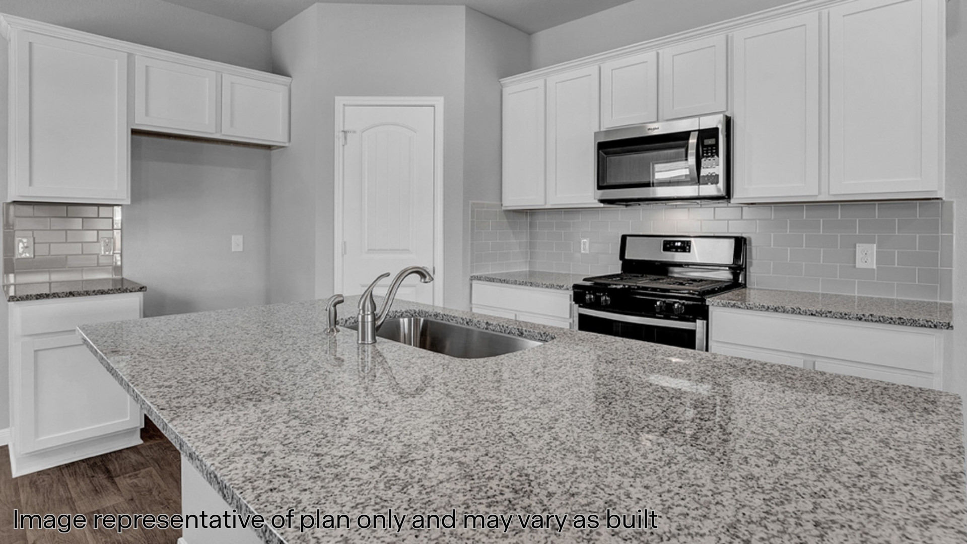 Kitchen with quartz countertops and stainless steel appliances