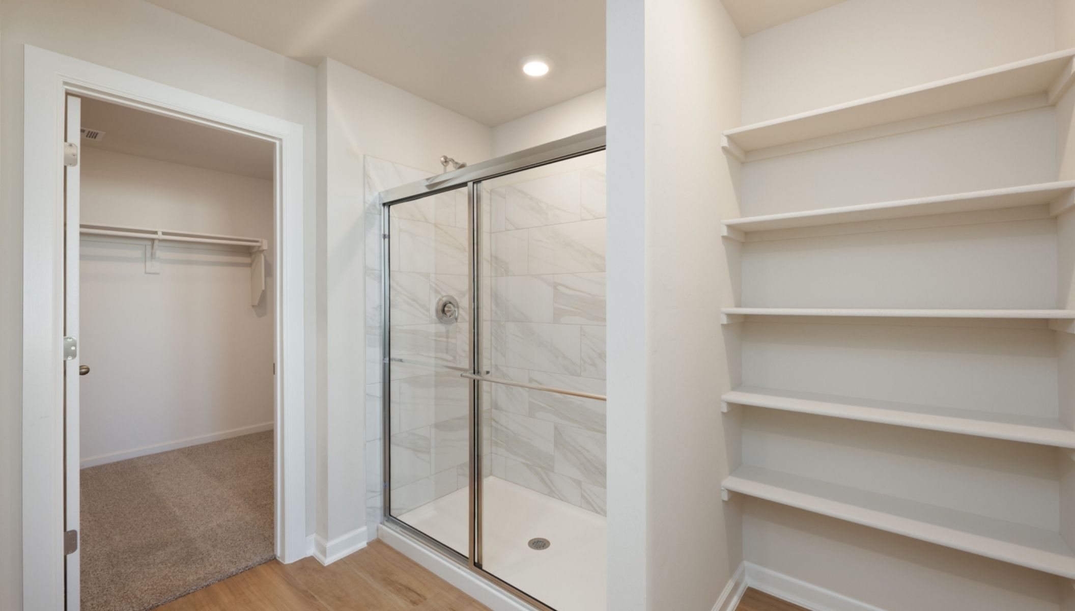 primary bathroom with shower and shelf