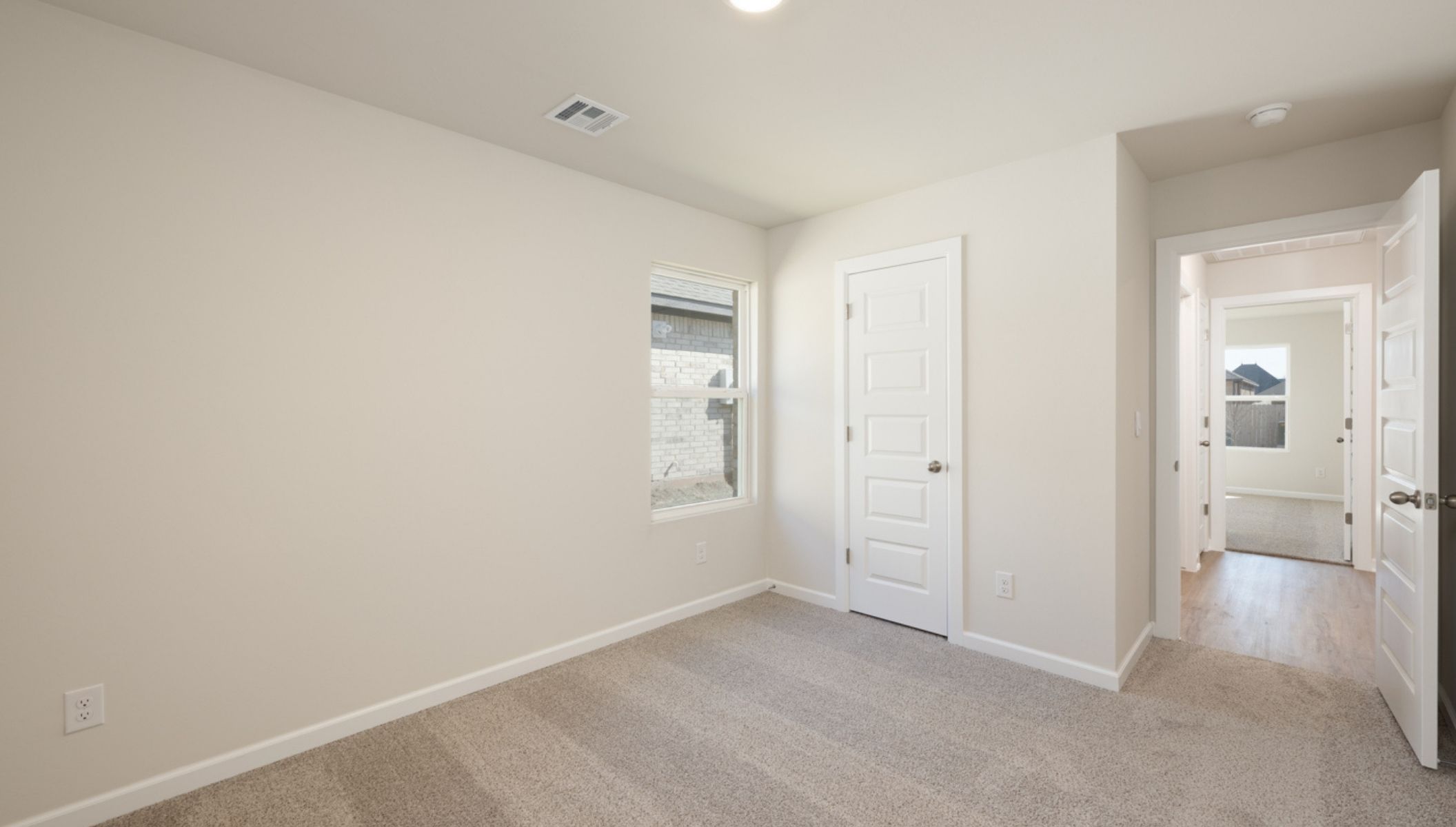 secondary bedroom with window and closet