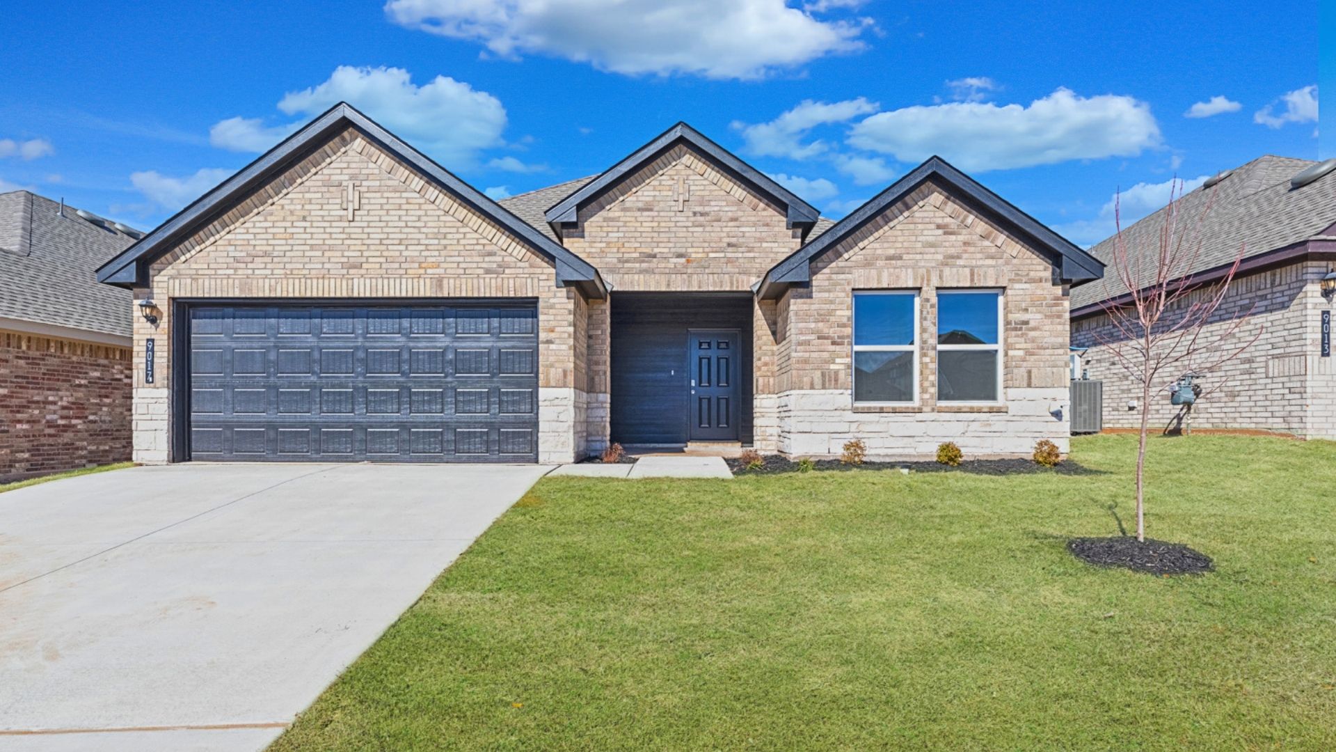 Single-story home rendering with two-car garage.