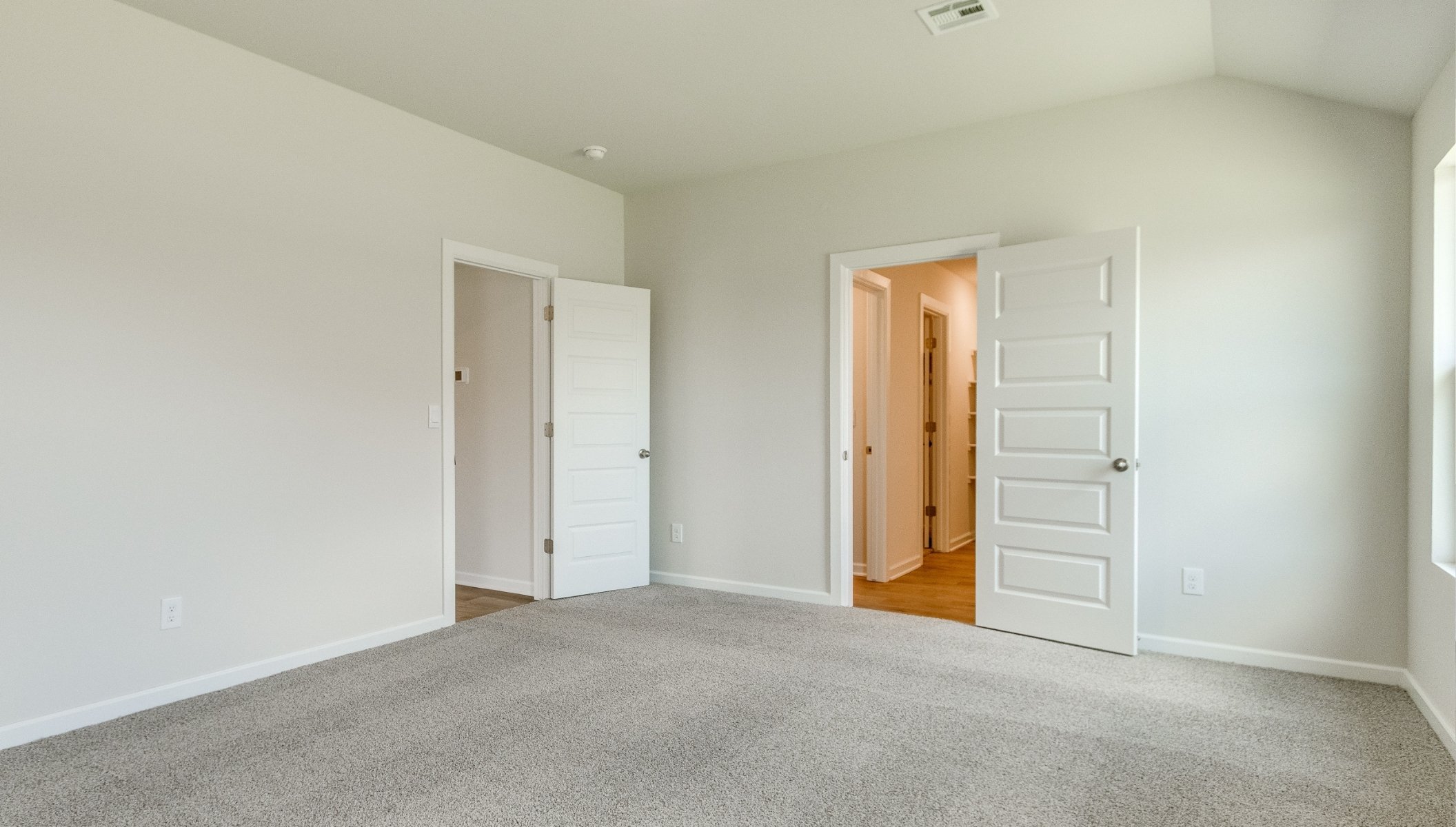 primary bedroom with carpet and ensuite bathroom