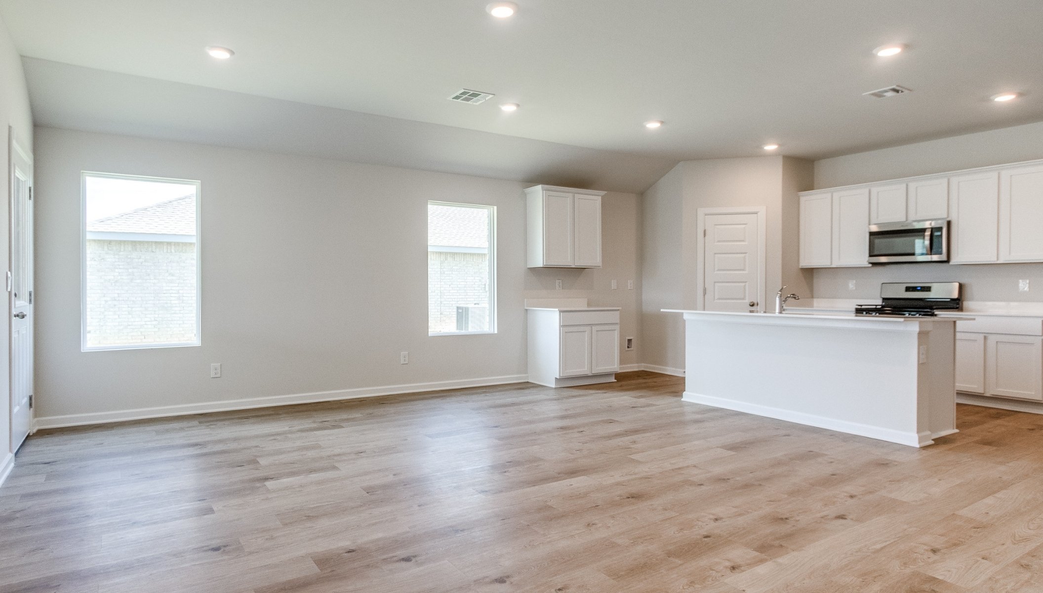 living area opening to kitchen