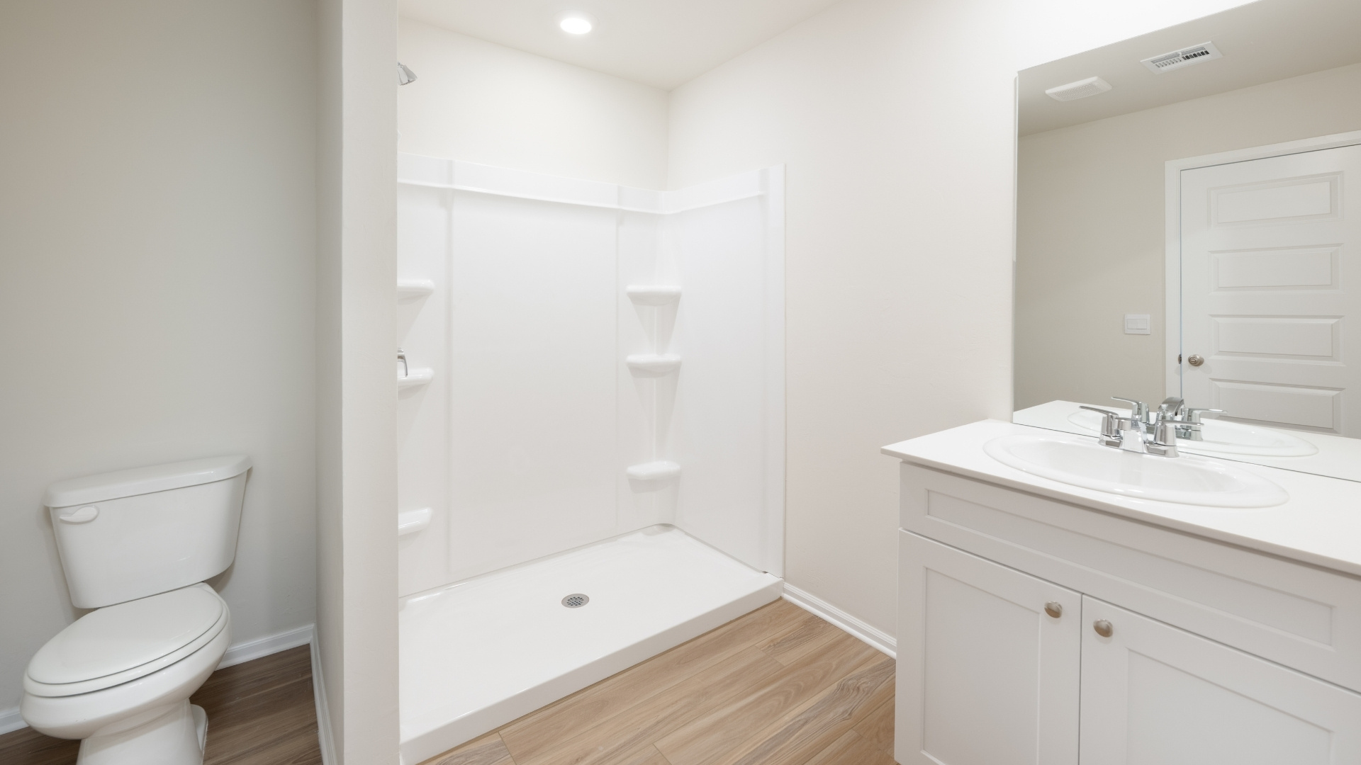 primary bathroom with shower and vanity