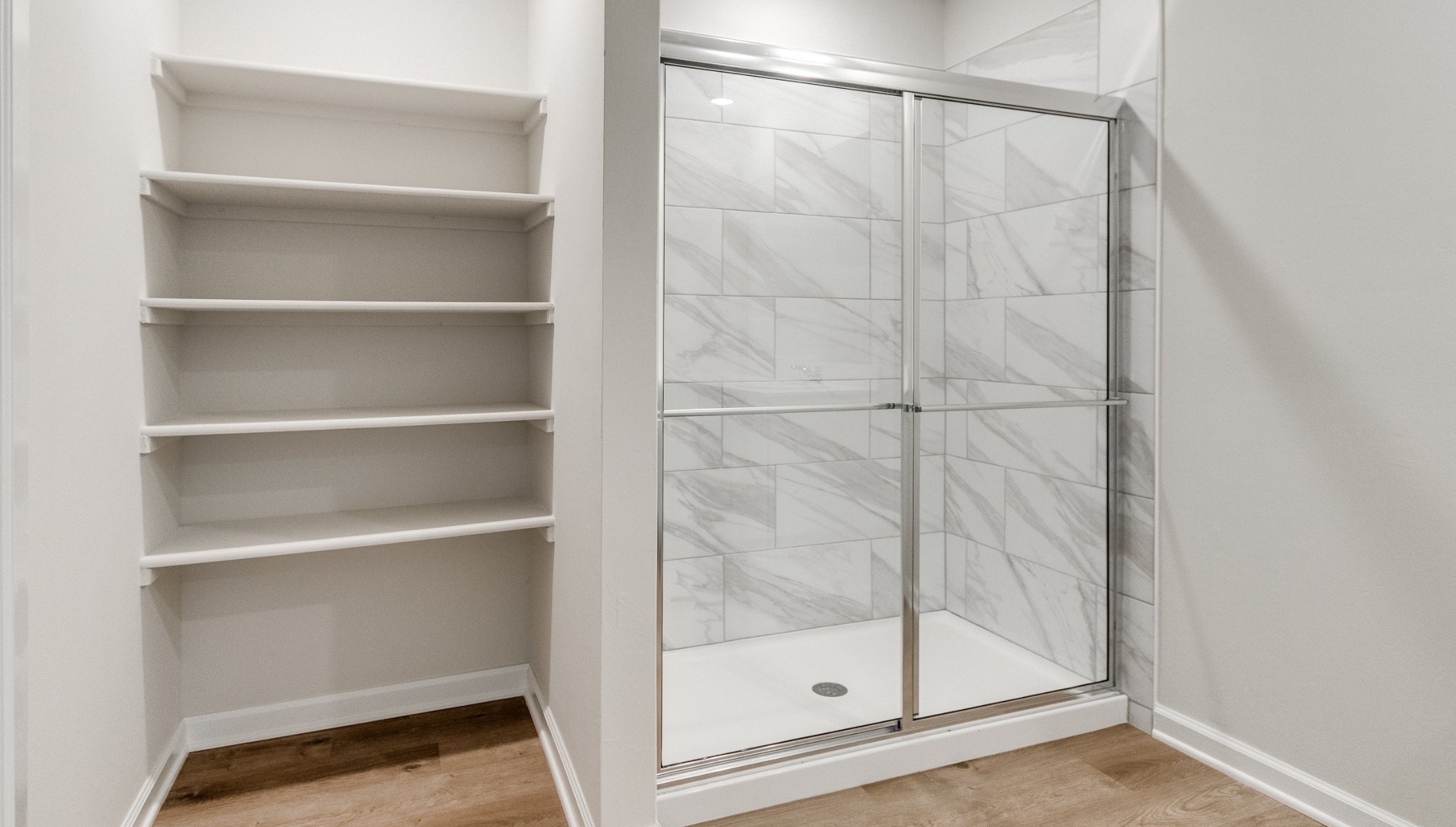 primary bathroom with shower and shelf