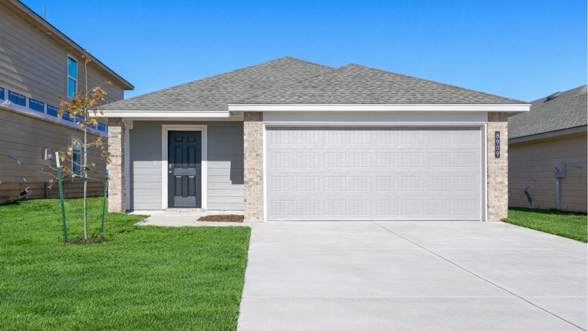 Single-story home rendering with two-car garage.