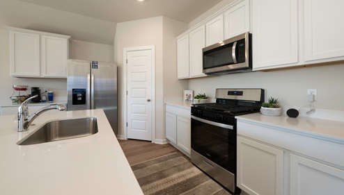 kitchen with painted cabinets and corner pantry