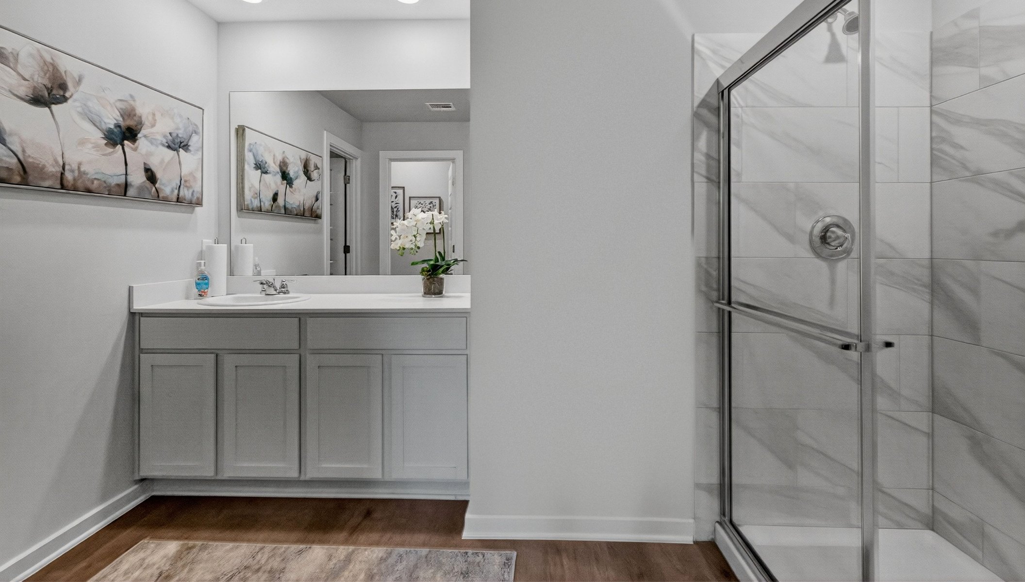 primary bathroom with vanity and shower
