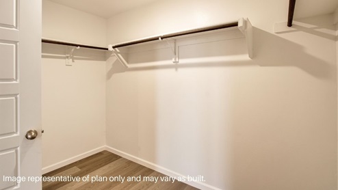 primary bathroom with walk in closet